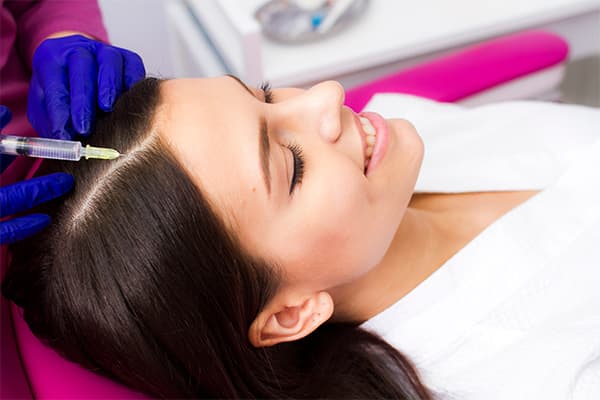 The-patient's-head-is-close-up,-the-patient-lies-in-the-cosmetologist's-office.